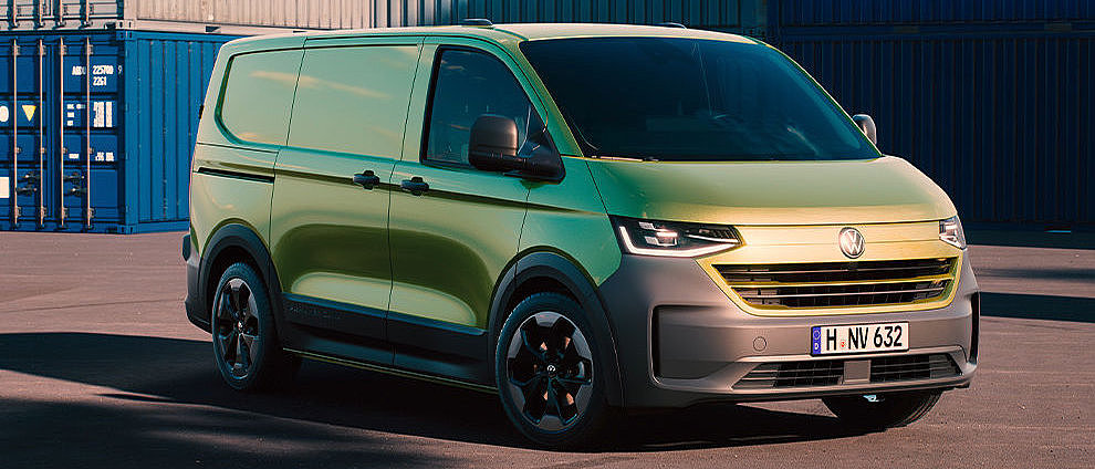 Volkswagen Transporter Kastenwagen in Grün vor Containern