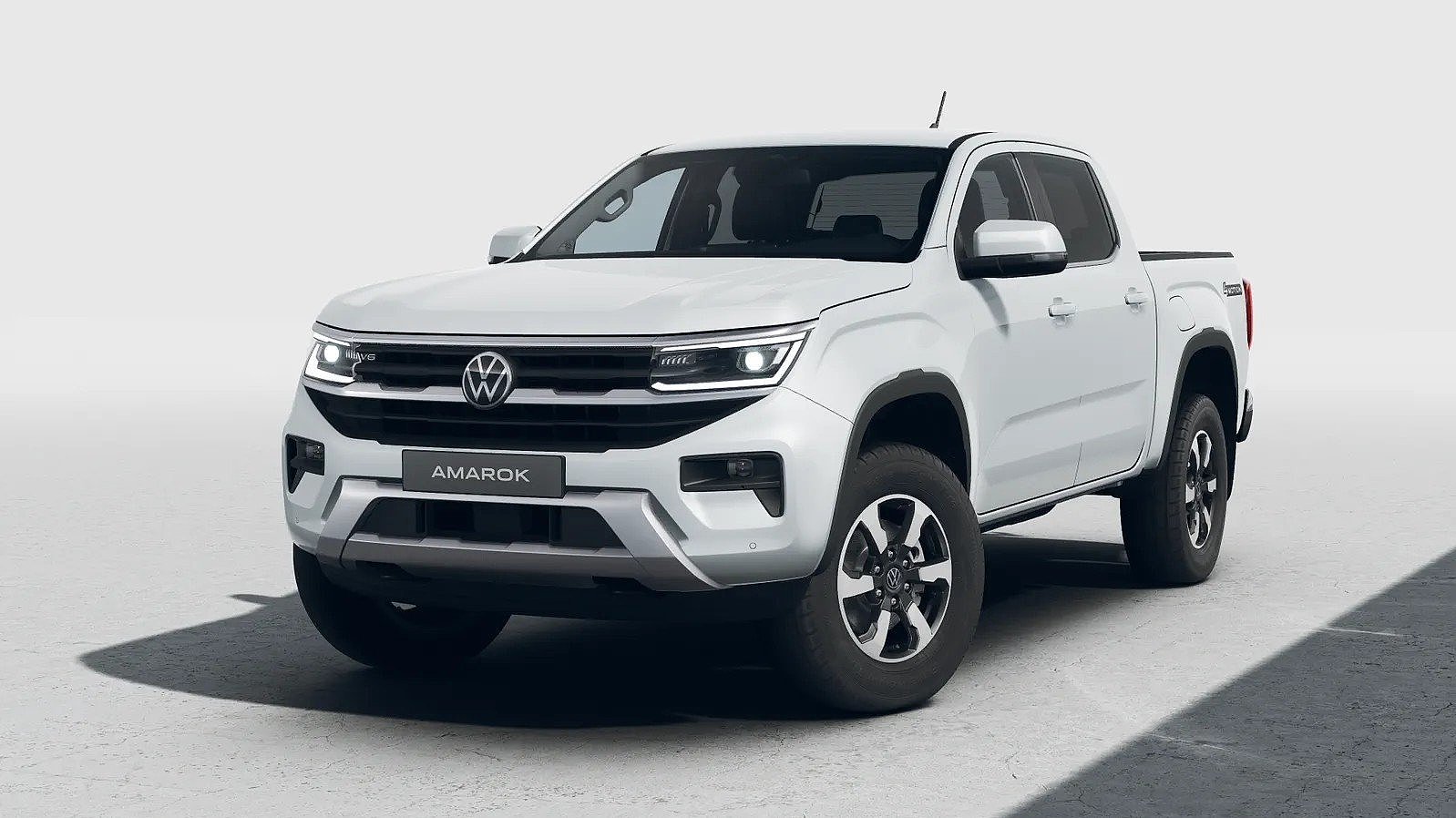 Weißer Volkswagen Amarok in schräger Frontansicht